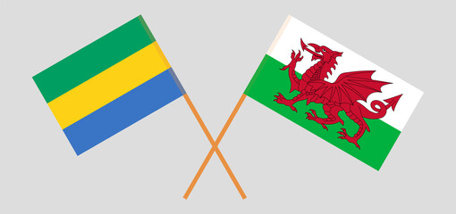 Crossed flags of Gabon and Wales. Official colors. Correct proportion