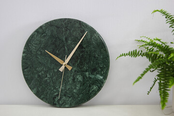 The time. Green marble clock. Wall clock on white background. 