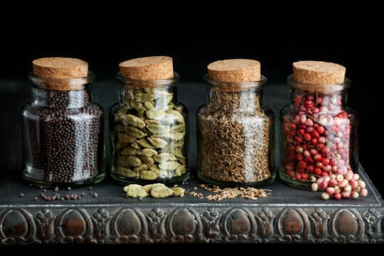 A set of small spice jars full with various colorful Indian Ayurveda spices  and herbs Stock Photo - Alamy
