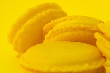 Yellow macaroons on yellow background