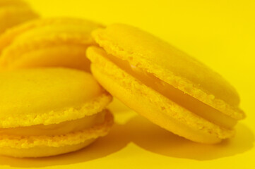 Fototapeta na wymiar Yellow macaroons on yellow background