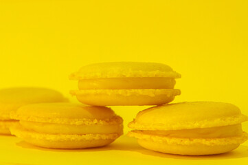 Yellow macaroons on yellow background