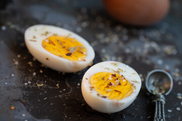 Hard Boiled Eggs with Salt and Seasoning on Distressed Background with shallow depth of field 