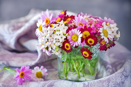 Beautiful bouquet of spring flowers in a vase on the table. Lovely bunch of flowers .Many beautiful fresh flowers on a table.