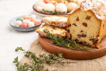 Homemade easter pie with raisins and eggs on plate on a gray concrete background. side view, selective focus.