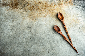 Two wooden spoons on a rustic table