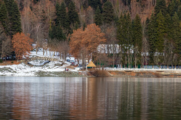 Mountain glacial lake Ritsa in Abkhazia. Abkhazia. Alpine Lake Ritsa. Tourists on catamaran sailing...