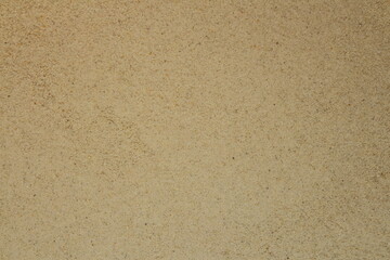 Sand background and texture. Top view of natural structured sandy beach surface.