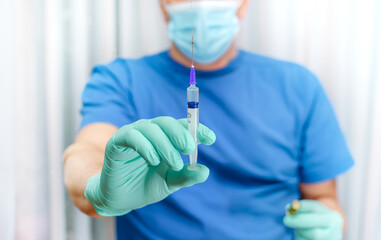 syringe in a man's hand