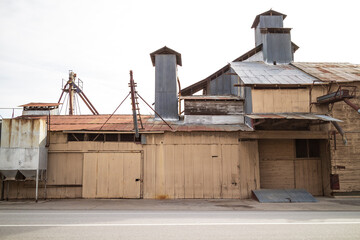 Fototapeta na wymiar Old Abandoned Warehouse Facility Exterior with Corrugated Siding