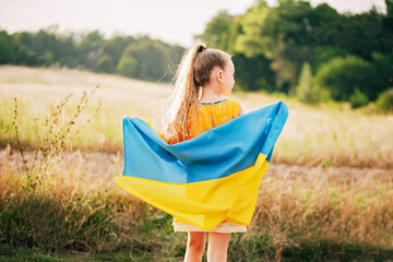Ukraine's Independence Flag Day. Constitution day. Ukrainian child girl in embroidered shirt...