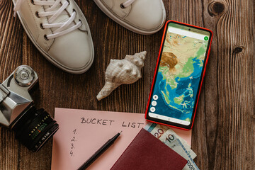 Travel concept banner flat lay.Items for summer vacation: passport,sneakers,money,smartphone with...