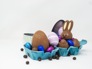 Chocolate Easter eggs with a happy Easter bunny
