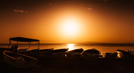 Sunset on a Caribbean Beach with boats