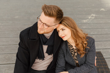 Beautiful young couple in boho style is standing by a lake. Lovers outside. Woman and man hug. Commitment. Couple outdoor spring