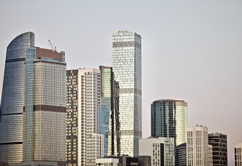 Group of Office and residential skyscrapers on bright clear blue sky background. Commercial real estate. Modern business city district. Office buildings exterior. Financial city district. Downtown.