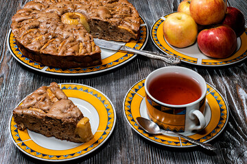 Sweet brown chocolate apple pie on the table made of natural wood