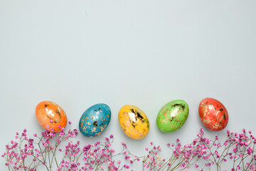Easter. They are framed by flowers and eggs. Easter card with a copy of the place for the text. Top view. Flat spoon