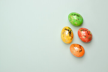 Four Easter eggs on a delicate background. Postcard with eggs on a light blue background. Layout for Easter. Minimalism.