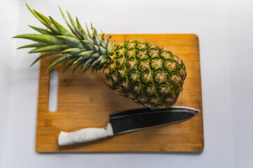 pineapple on a wooden cutting board