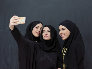 Portrait of Arab women wearing traditional clothes or abaya taking selfie