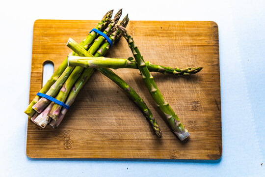 asparagus on wooden cutting board