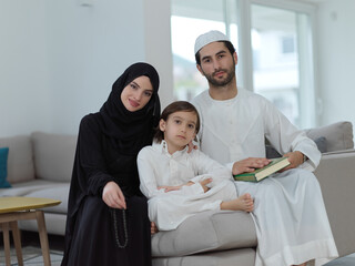 Young muslim family reading Quran during Ramadan