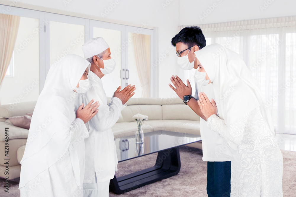 Wall mural Parents wear face mask and handshake with children