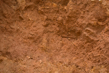 abstract side view of carving mountain earth soil, yellow or red color tone, oxidized and very fertile 
soil red clay background, texture, full frame, flat surface backdrop for photography