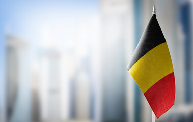 A small flag of Belgium on the background of a blurred background