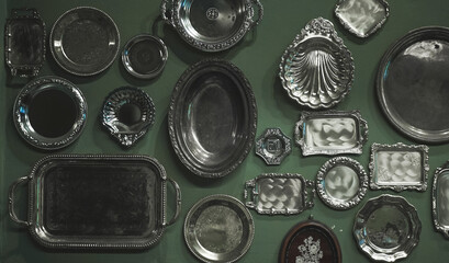 Vintage trays. Top view of different kind of trays on the green background. Noise filter to create Vintage film grained effect.