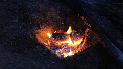 Glowing embers in a camp fire