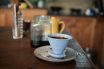 preparing brewing coffee with coffee maker and drip kettle.