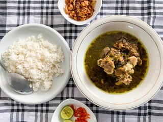 Nasu Cemba is a traditional food from Enrekang, South Sulawesi, Indonesia. Made from beef ribs and some condiments, served with rice, fried onion, chilli and kaffir lime.