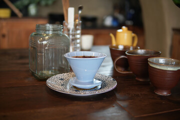preparing brewing coffee with coffee maker and drip kettle.