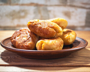 Fried pies on a clay plate close-up for a breakfast