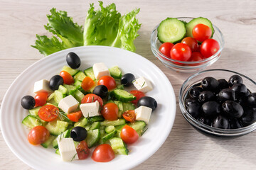 Fresh vitamin salad with tomatoes, olives, cucumber, feta and spices for a healthy snack. 