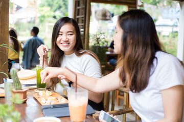 Business women in casual talking with friend in coffee shop