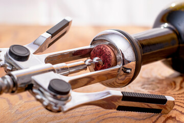 a bottle of dry red wine with a corkscrew stuck in the cork close up