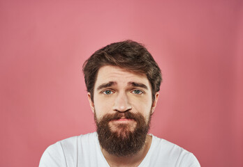 Male cropped view portrait of brunet bushy beard white t-shirt