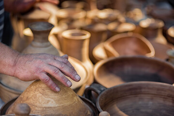 Fototapeta na wymiar Stall with handmade ceramic souvenir bowls and dishes for sale