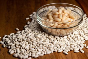 dry white beans and a bowl with cooked beans.