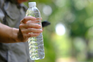 bottle of water in green natural background and space