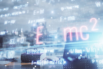 Double exposure of formula drawing and desk with open notebook background. Concept of education