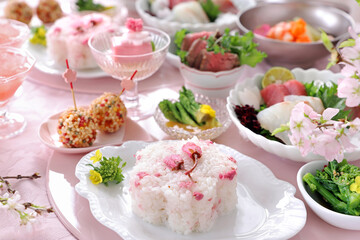Home made spring lunch plate with cherry blossom rice, roast beef, sashimi, spring vegetables,...