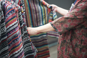 old senior elder woman choosing clothes at store shop