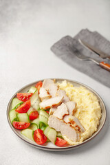 Chicken breast grill with mashed potatoes and vegetables in a plate on the table. Diet nutrition