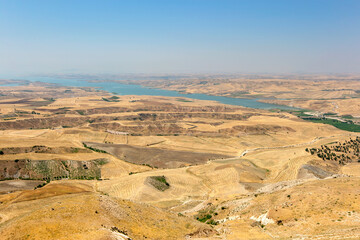 A patchwork of fields showing harvested grain crops which lie adjacent to Ataturk Dam (GAP) near Samsat in the Adiyaman Province of eastern Turkey.