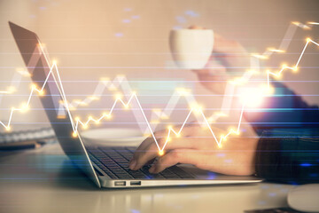 Double exposure of businesswoman hands typing on computer and forex graph hologram drawing. Financial analysis concept.