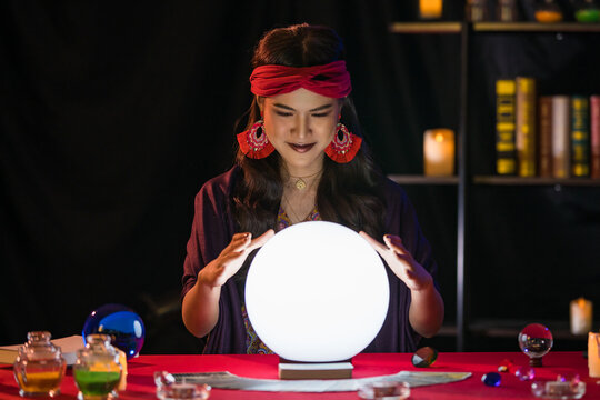 Asian fortune teller in dark room